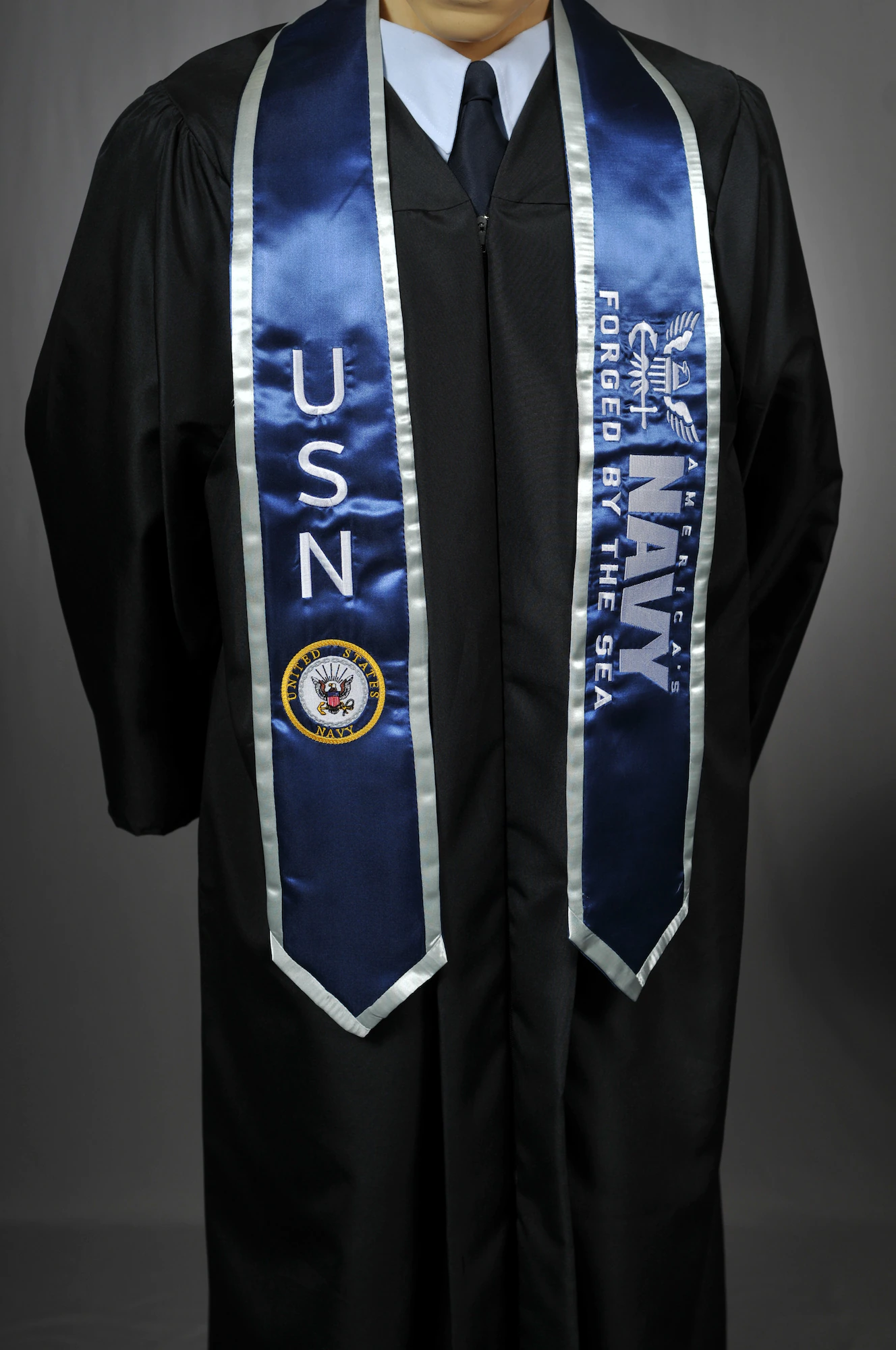 Close-up of embroidered stoles for university graduation with logos and colors.
