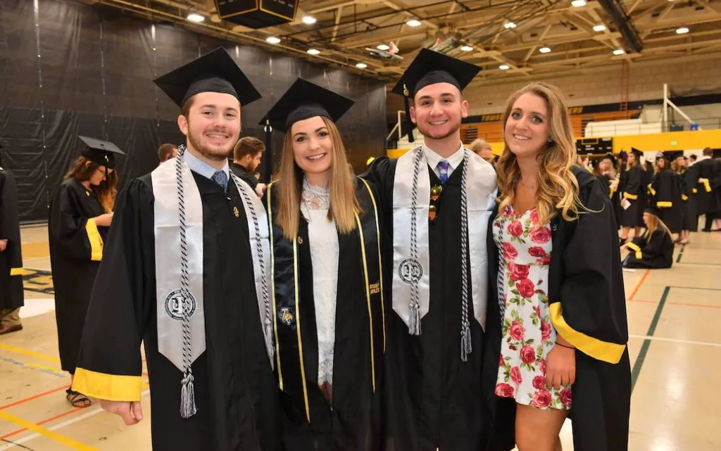Graduates wearing embroidered stoles representing different departments