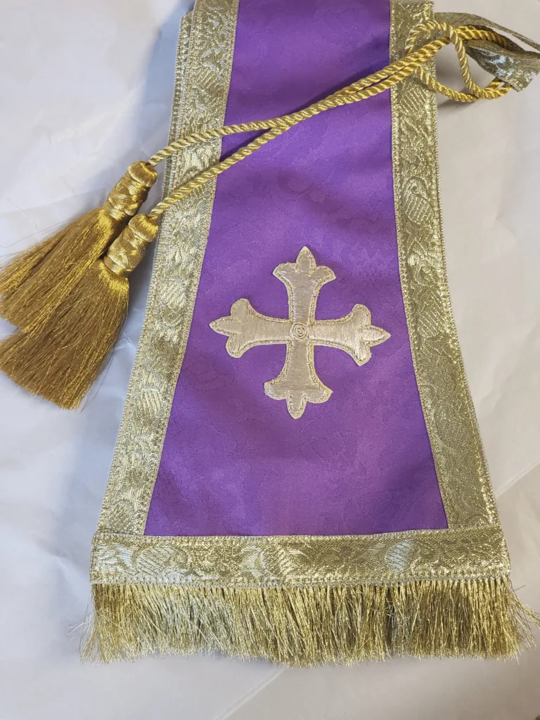 clergy stole embroidery close-up with cross and flame